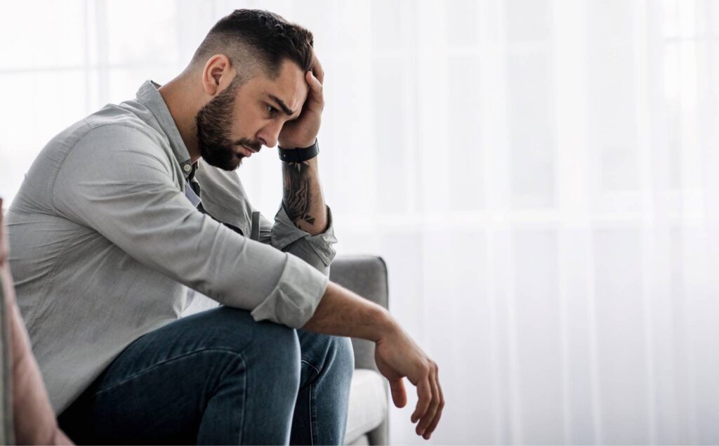 Man dealing with the emotional impact of heroin addiction.