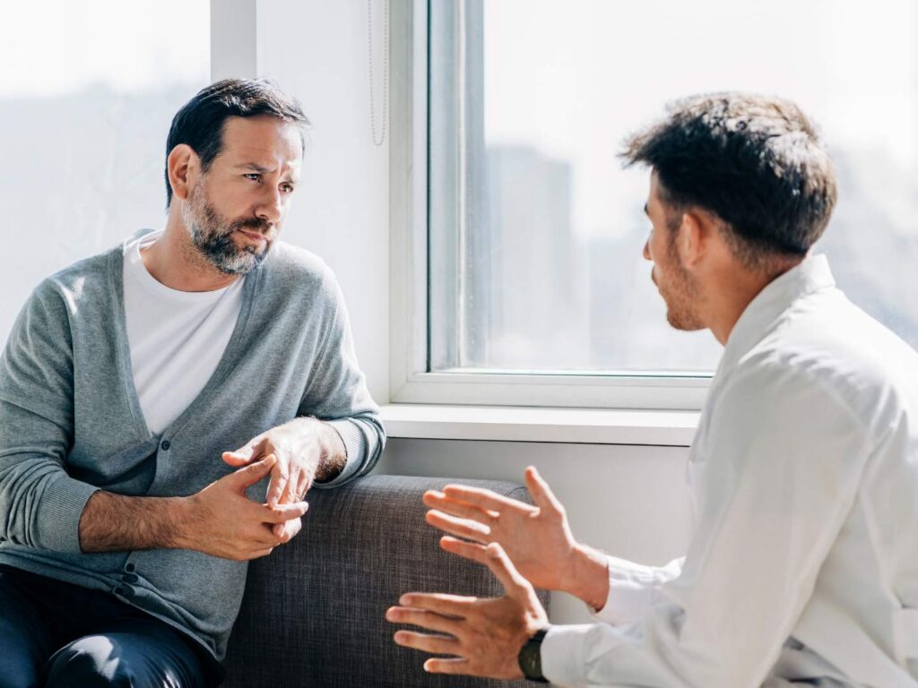 Man speaking with a therapist at a professionals and executives rehab in Nashville.