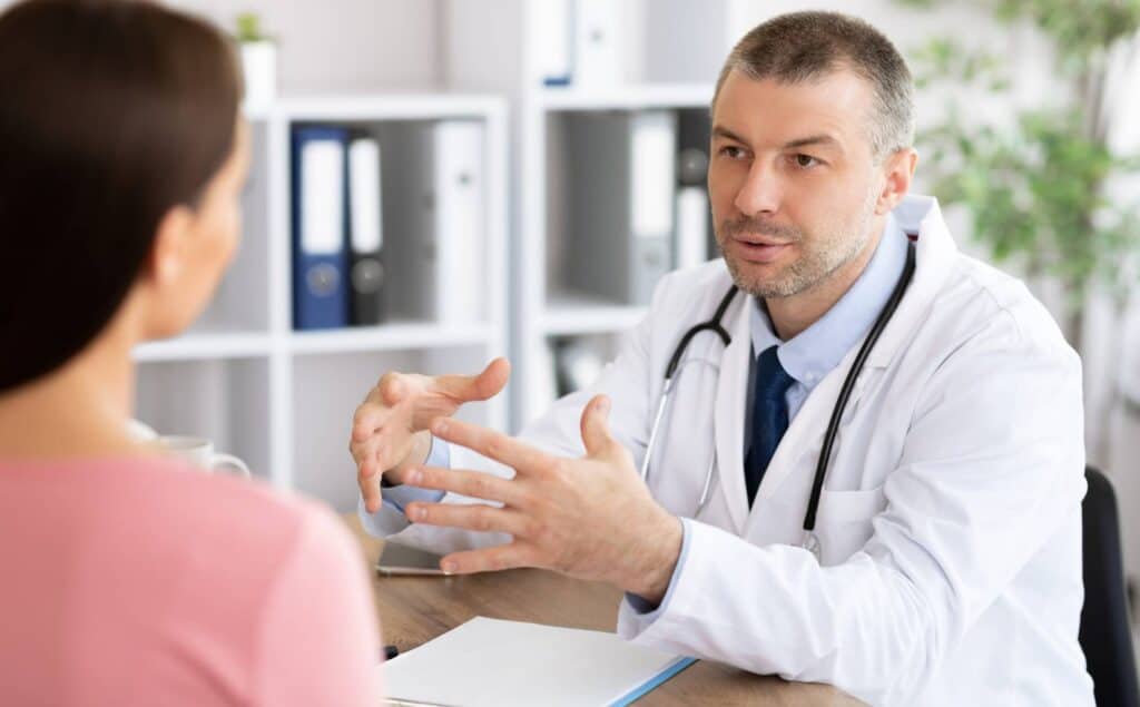 Physician helping a client navigate hallucinogen addiction treatment in Nashville.
