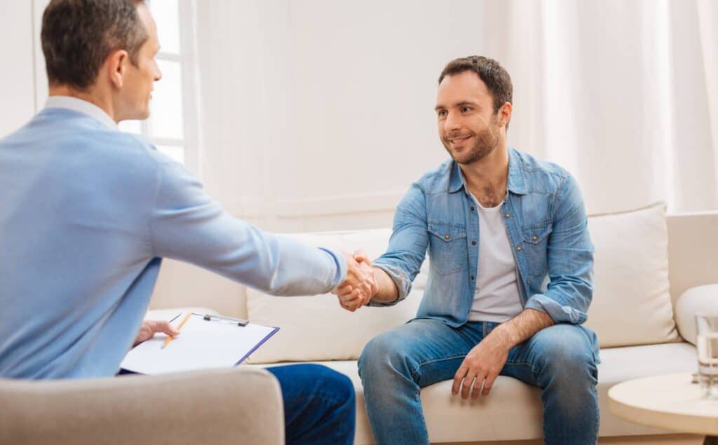 Physician welcoming a patient at a hallucinogen addiction treatment center in Nashville.