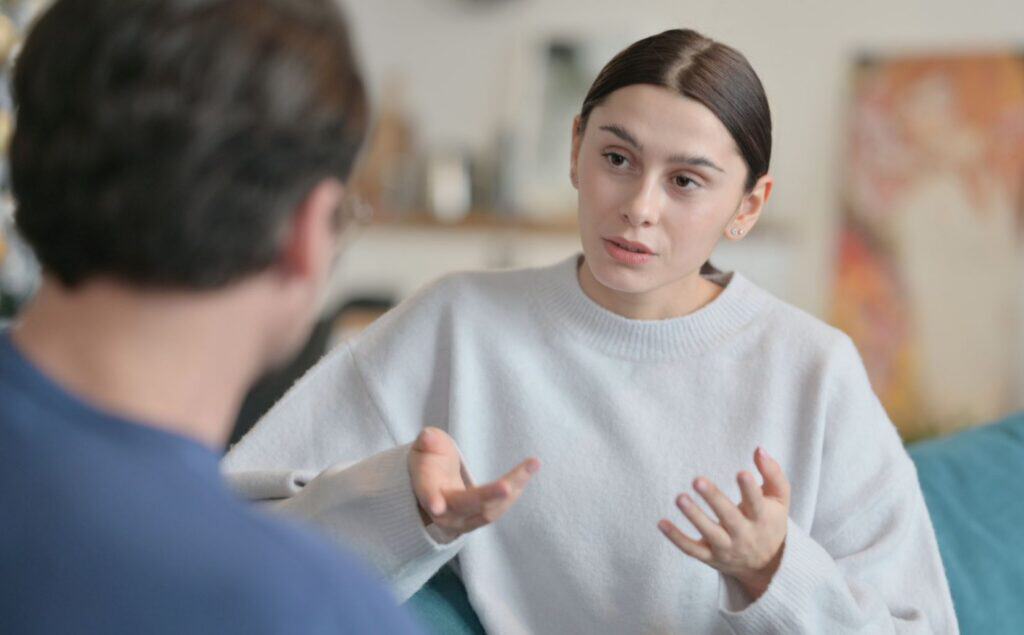 Therapist explaining the difference between panic attacks and panic disorder and discussing treatment options with a client.