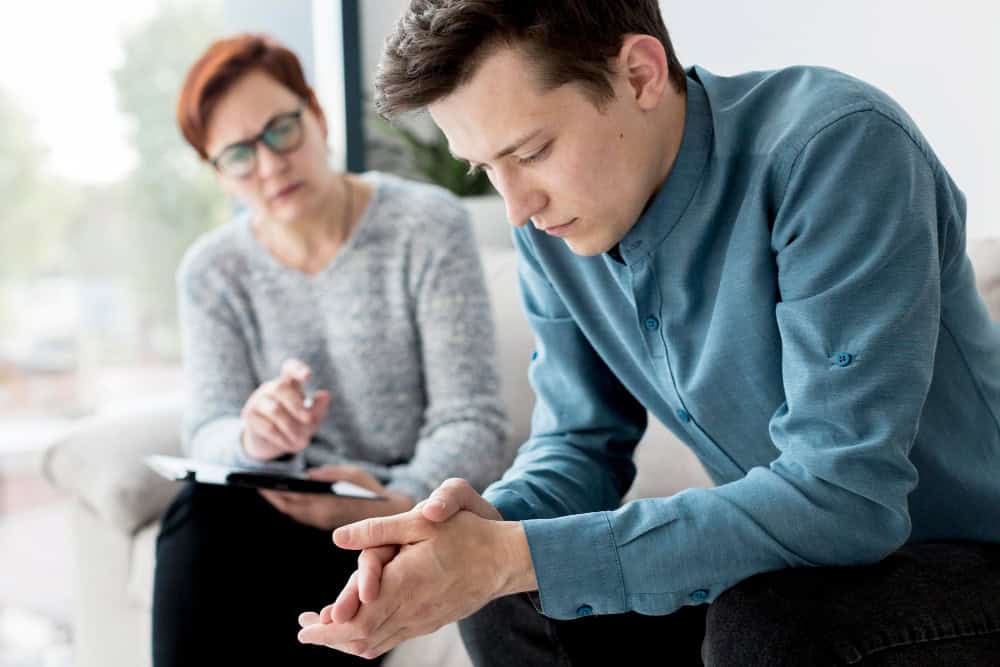 Psychologist and patient discussing symptoms of undiagnosed ADHD in adults during an individual therapy session.